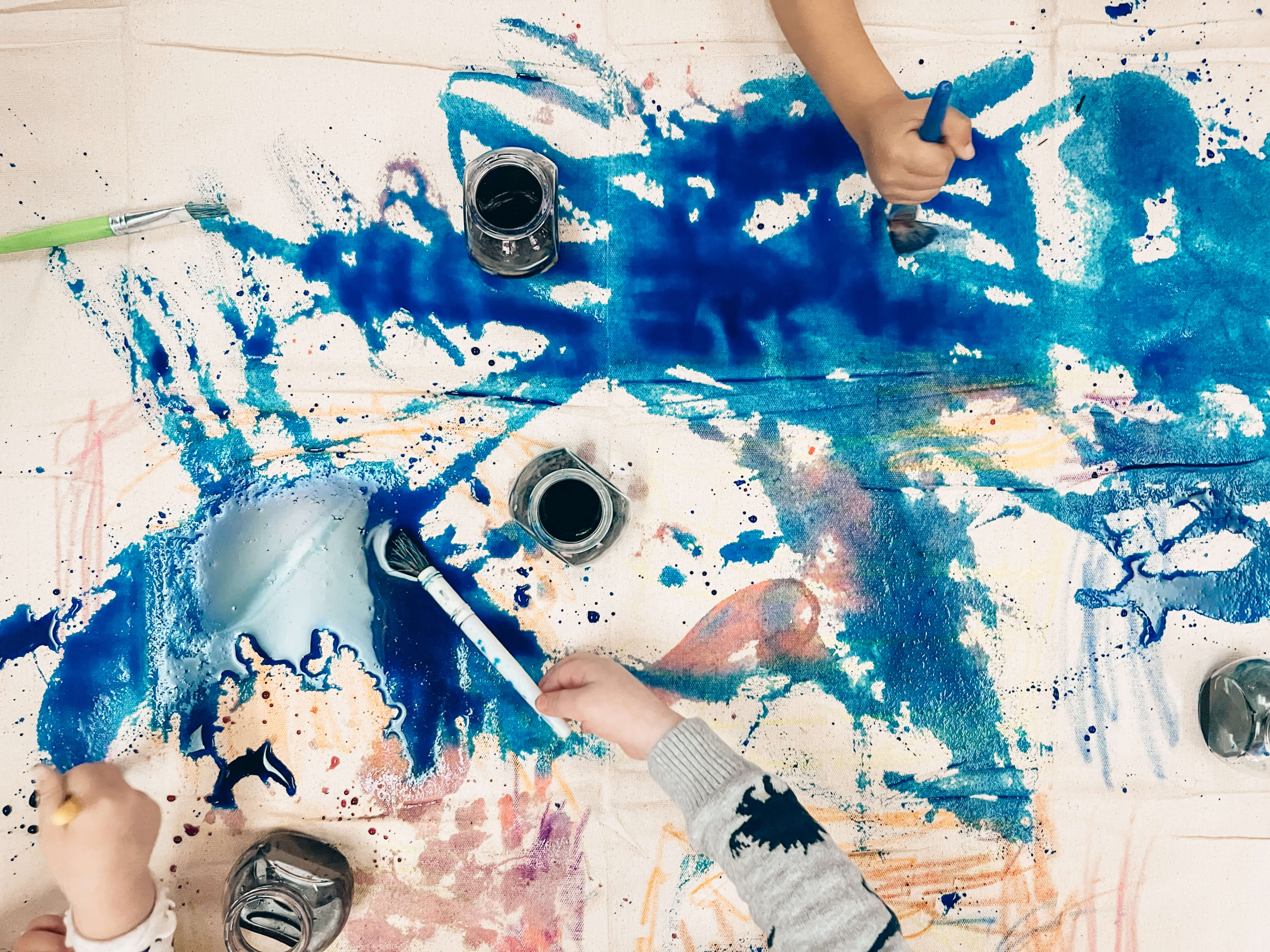 Children expressing themselves through art using paintbrushes