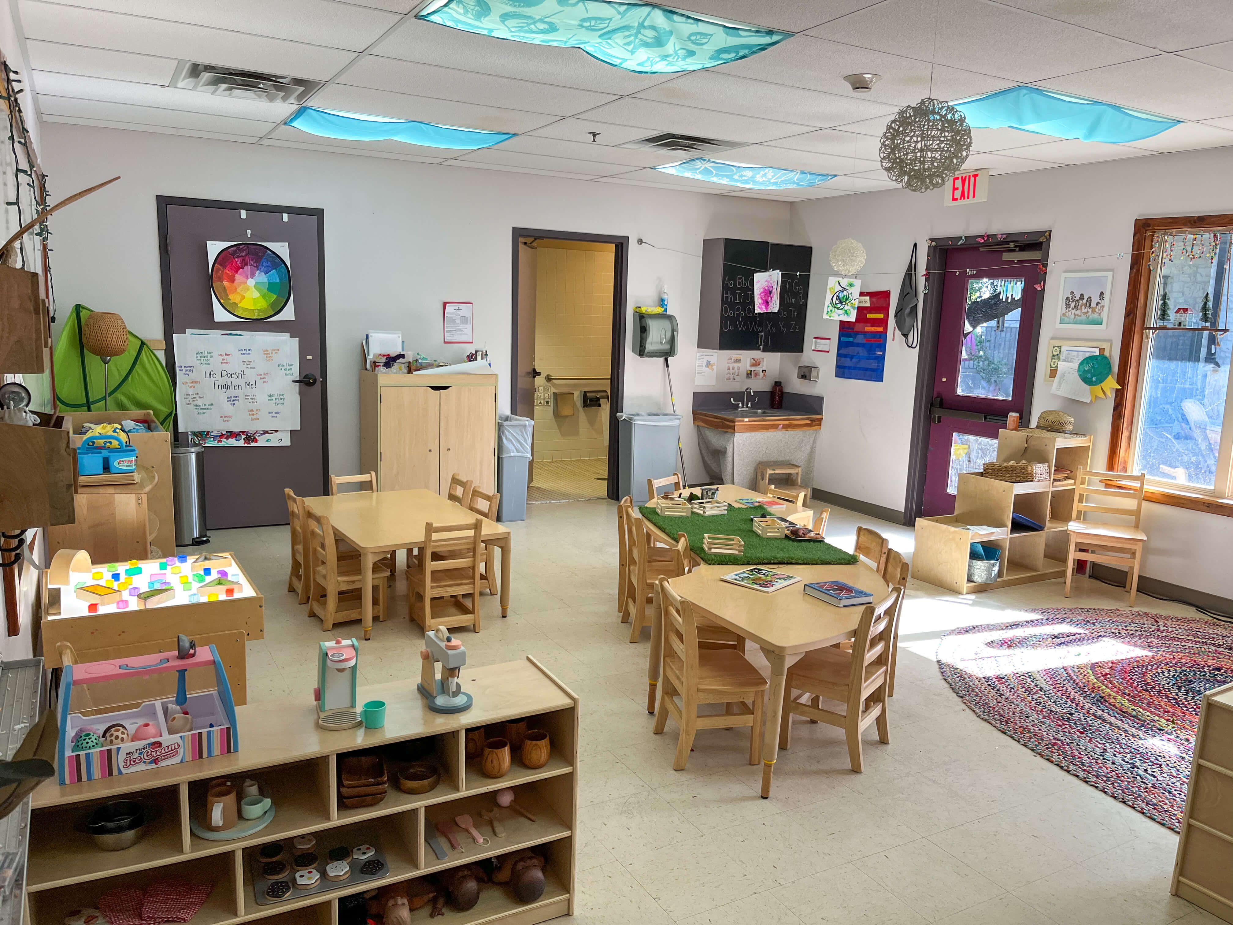 A picture of a classroom with set tables for play