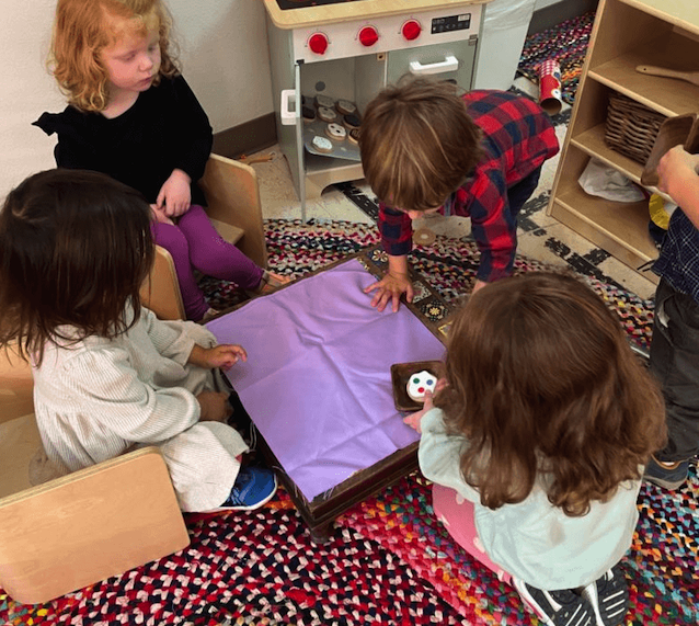 Children gathered around a small floor table