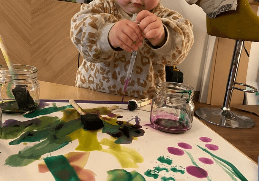 Children working with different artistic mediums in the atelier